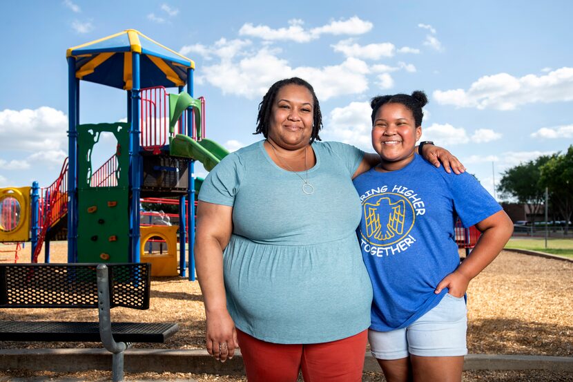 Ebony Booker, a medical massage therapist, poses for a portrait with her daughter Madison...