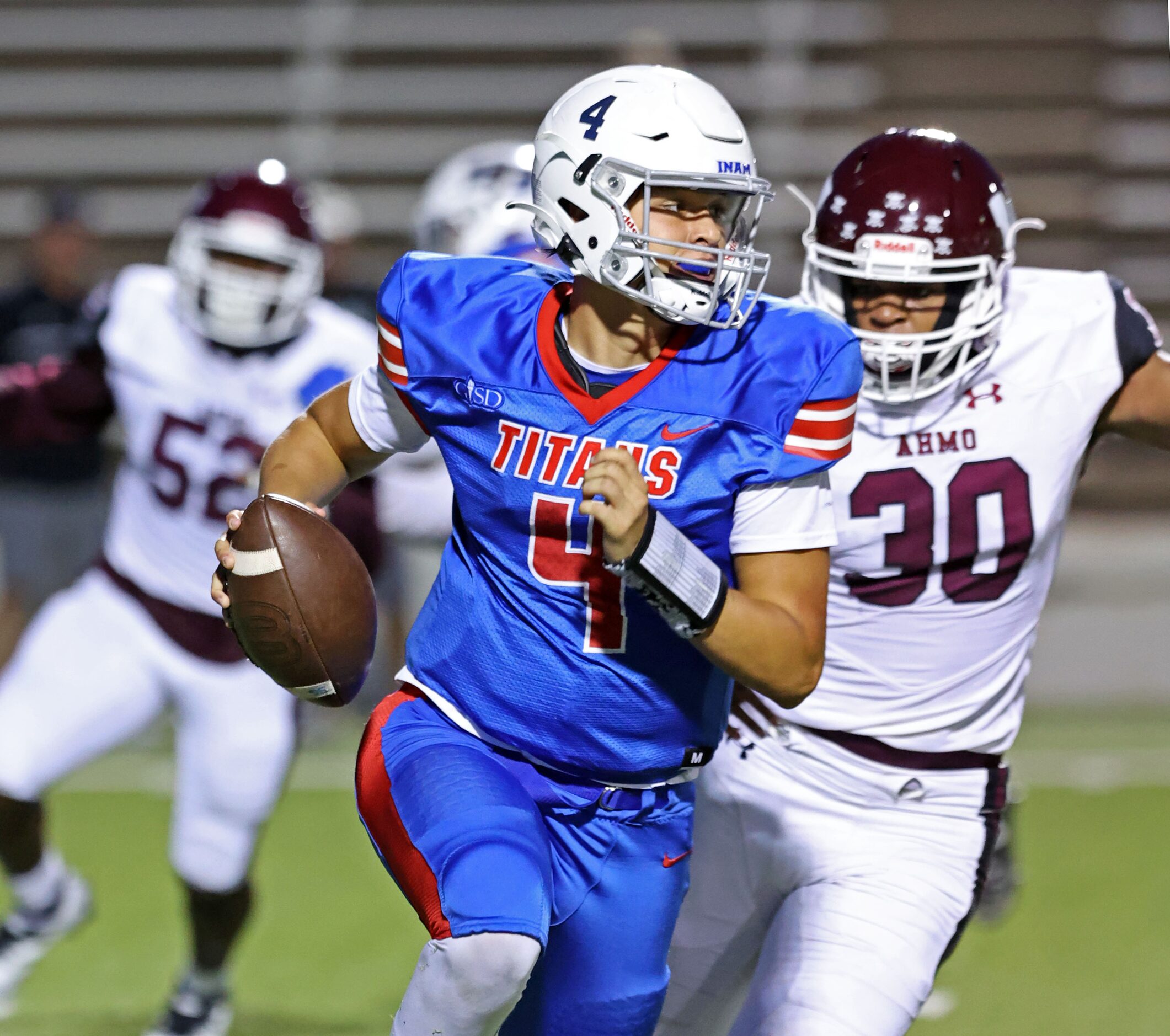 South Garland QB Mirko Martos (4) tries to escape from Wylie High defender Terry Harton (30)...