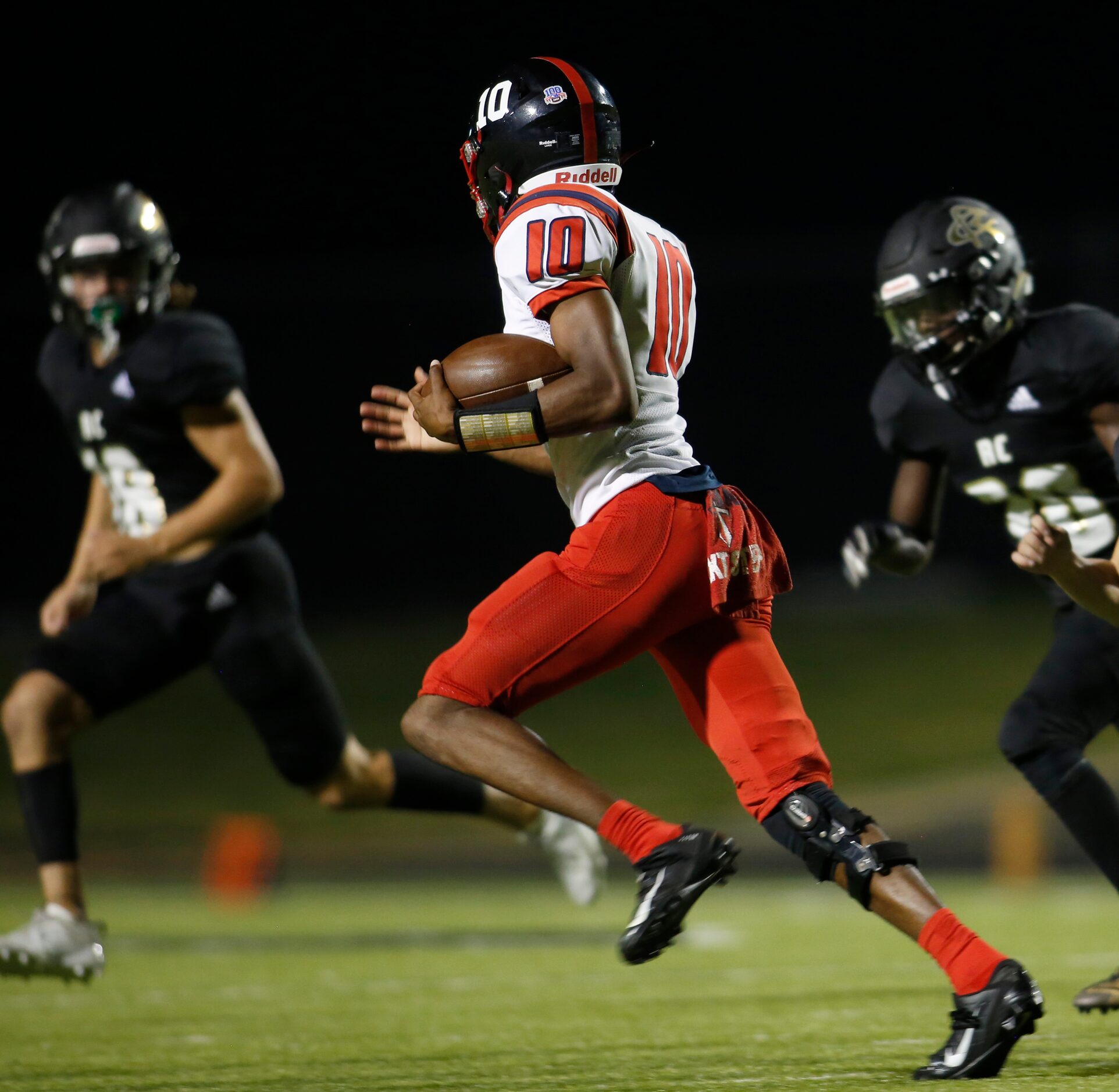 Frisco Centennial quarterback Grayson Dayries (10) looks for running room as he scampers...