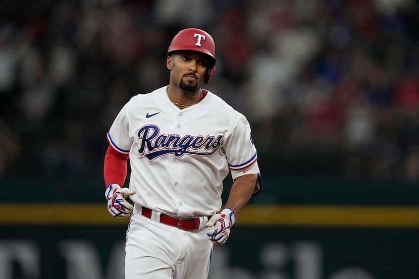Texas Rangers' Marcus Semien runs the bases after hitting a three-run home run off Seattle...