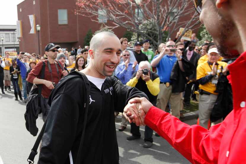 Virginia Commonwealth University men's basketball coach Shaka Smart, shakes the hand with a...