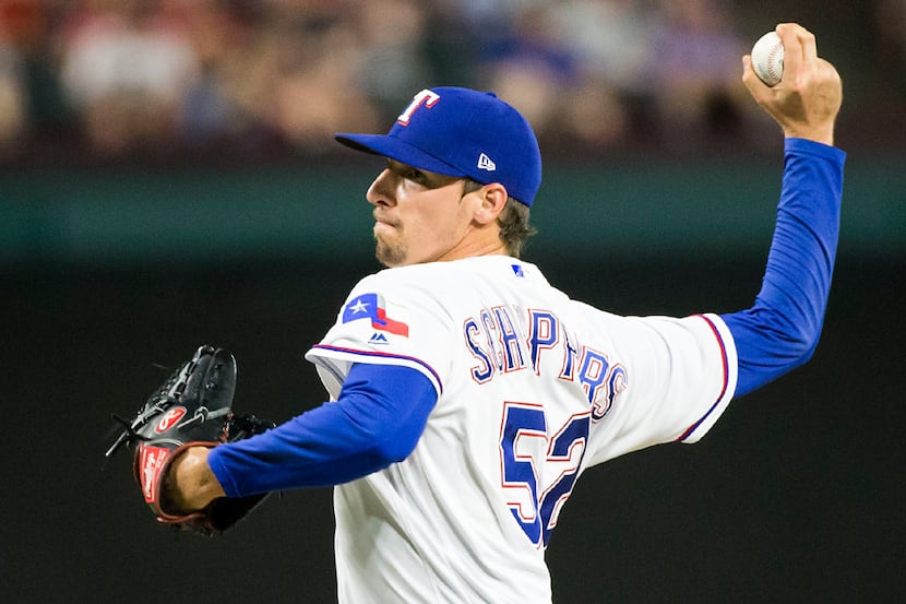 Texas Rangers relief pitcher Tanner Scheppers pitches during the eighth inning against the...