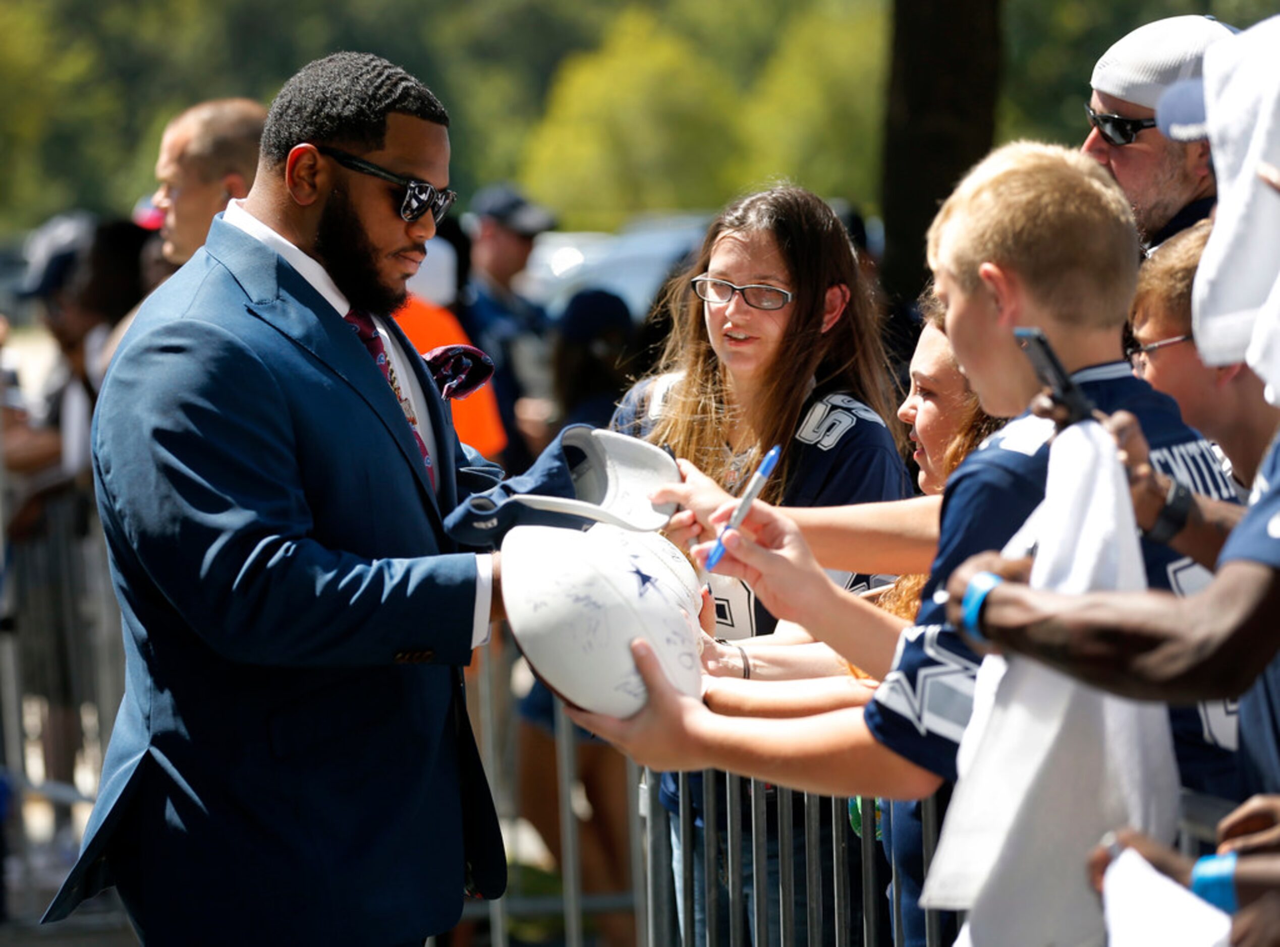 Dallas Cowboys defensive tackle Antwaun Woods signs autographs as he arrives at AT&T Stadium...