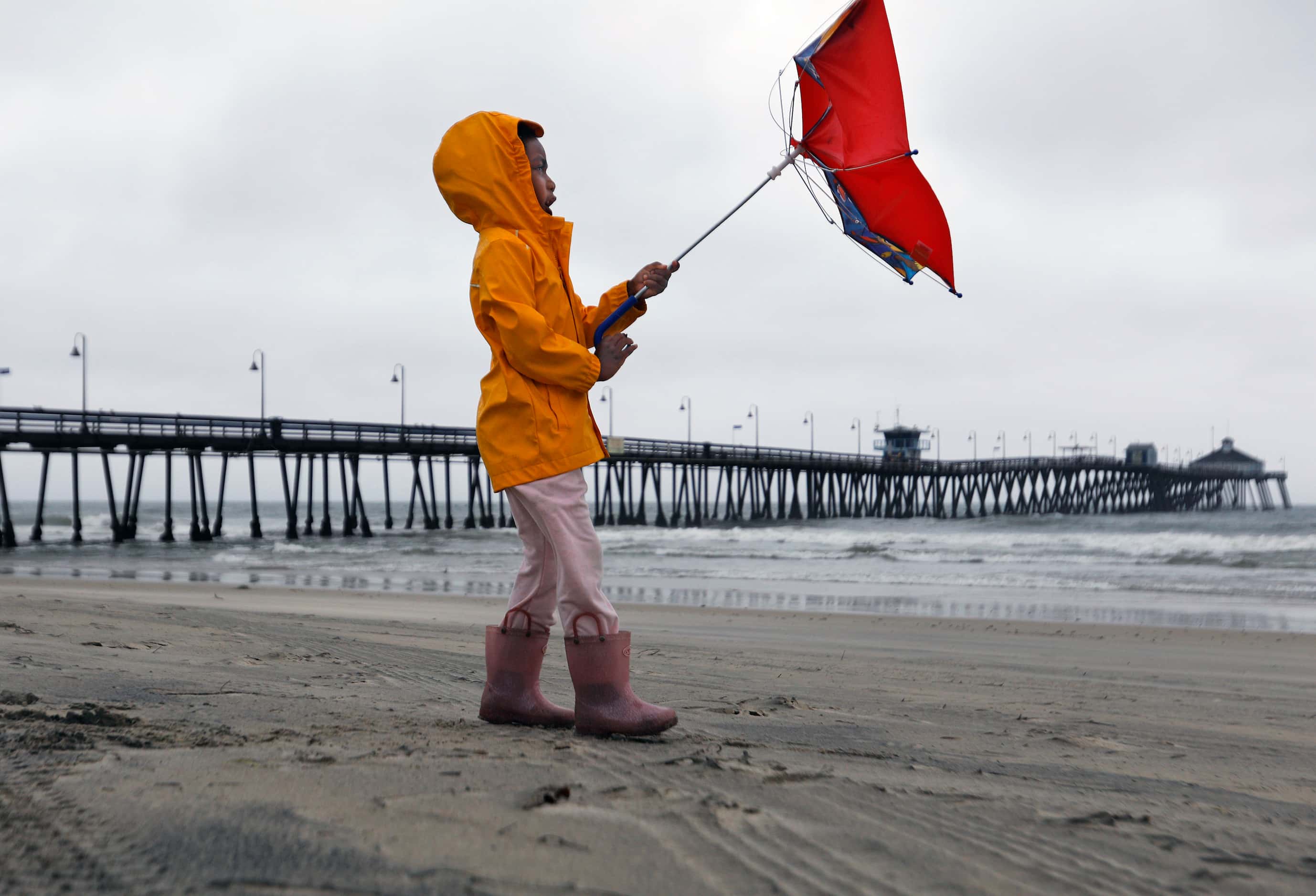 Reagan King battles the wind while out with her parents at Imperial Beach after the eye of...