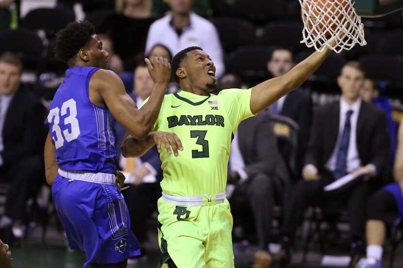 Baylor guard King McClure, right, drives past New Orleans guard Ezekiel Charles during the...