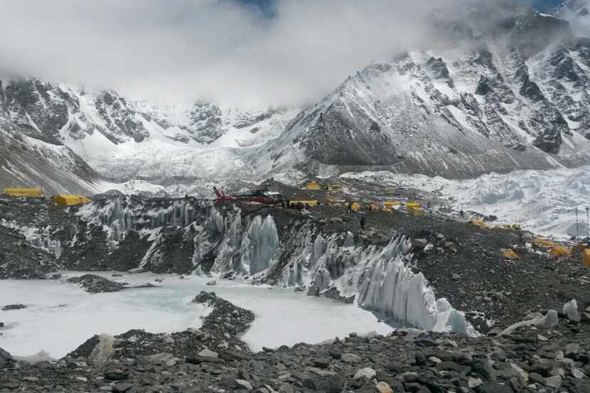 A rescue chopper carries people from higher camps to Everest Base Camp in Nepal, Monday,...