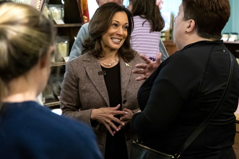 Democratic presidential nominee Vice President Kamala Harris, center, speaks with patrons...