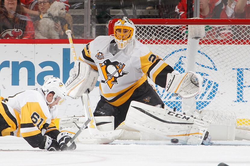 NEWARK, NJ - DECEMBER 27:  Goalie Marc-Andre Fleury #29 of the Pittsburgh Penguins stops a...