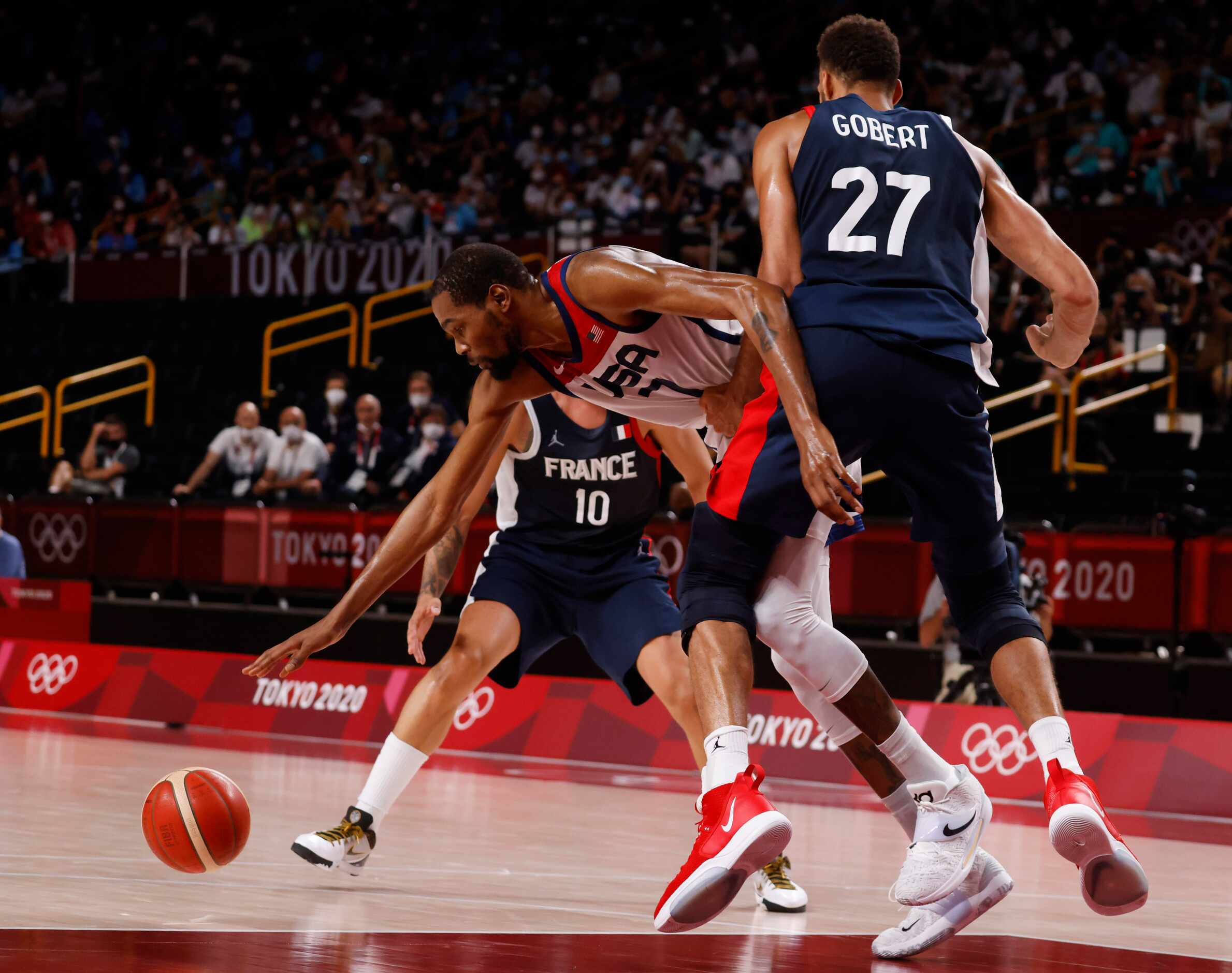 USA’s Kevin Durant (7) is fouled by France’s Rudy Gobert (27) during the second half of play...