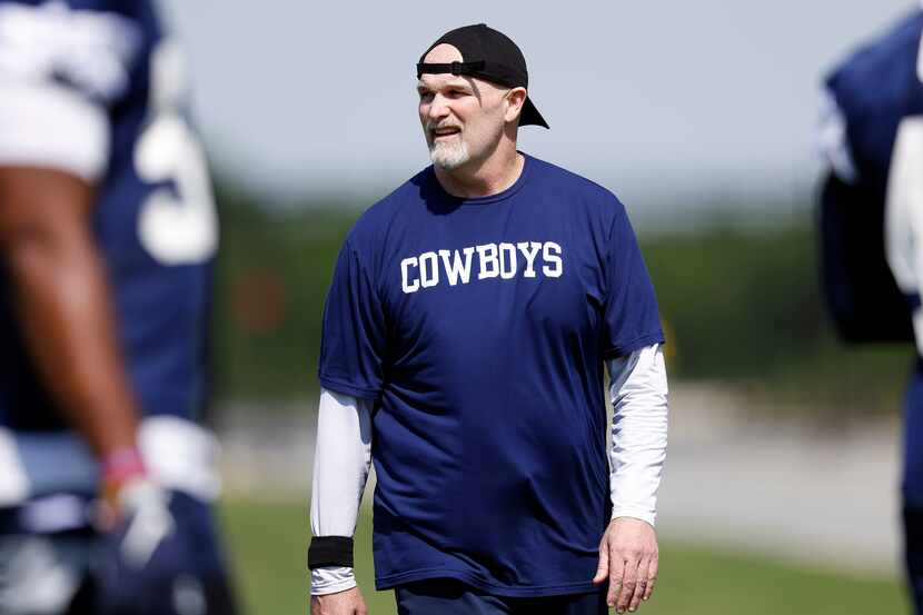 Dallas Cowboys defensive coordinator Dan Quinn watches his players during rookie minicamp at...