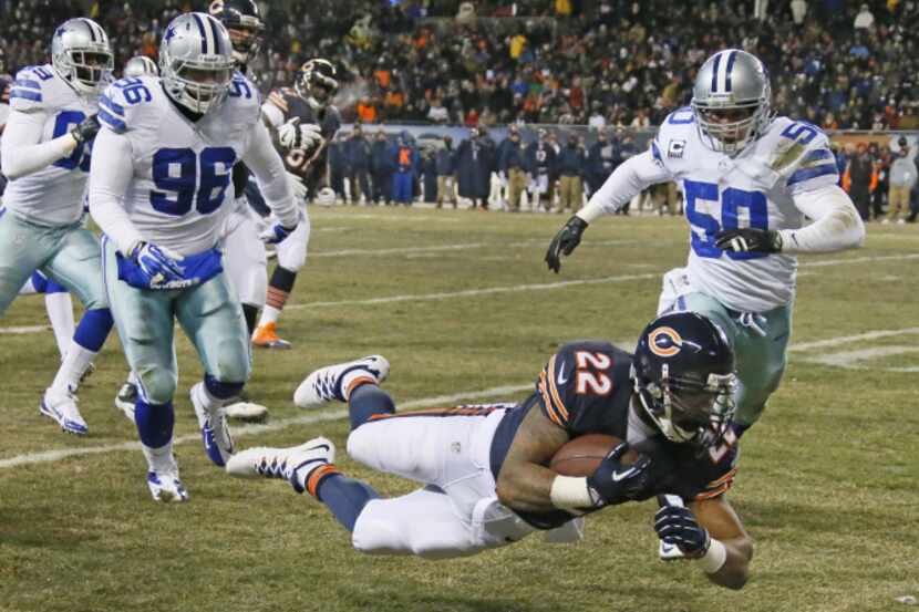 Chicago Bears running back Matt Forte (22) dives forward for yardage as Dallas Cowboys...