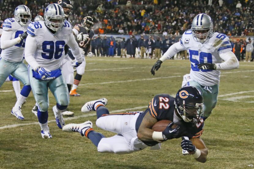 Chicago Bears running back Matt Forte (22) dives forward for yardage as Dallas Cowboys...