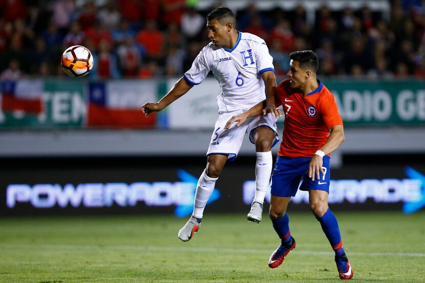 Honduras' Bryan Acosta (L) vies for the ball with Chile's Alexis Sanchez during a friendly...
