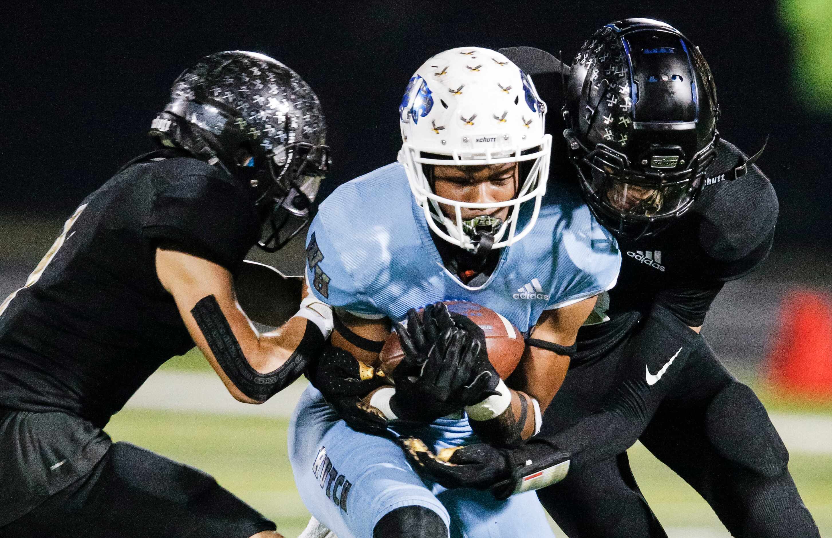 Wilmer-Hutchins senior wide receiver Jalin Moore (7) is tackled by Kaufman defenders during...