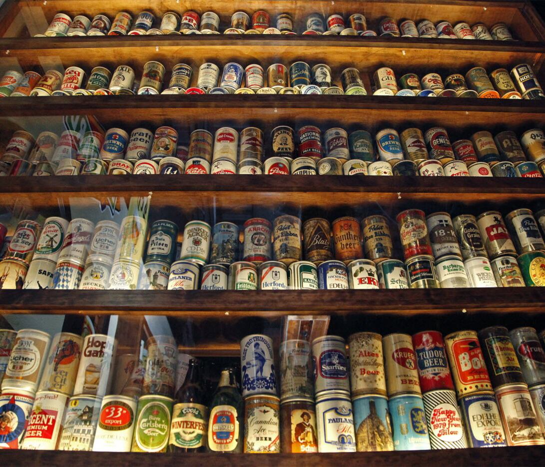 A showcase filled with beer cans and bottles from around the world at Ron's Place in Addison...