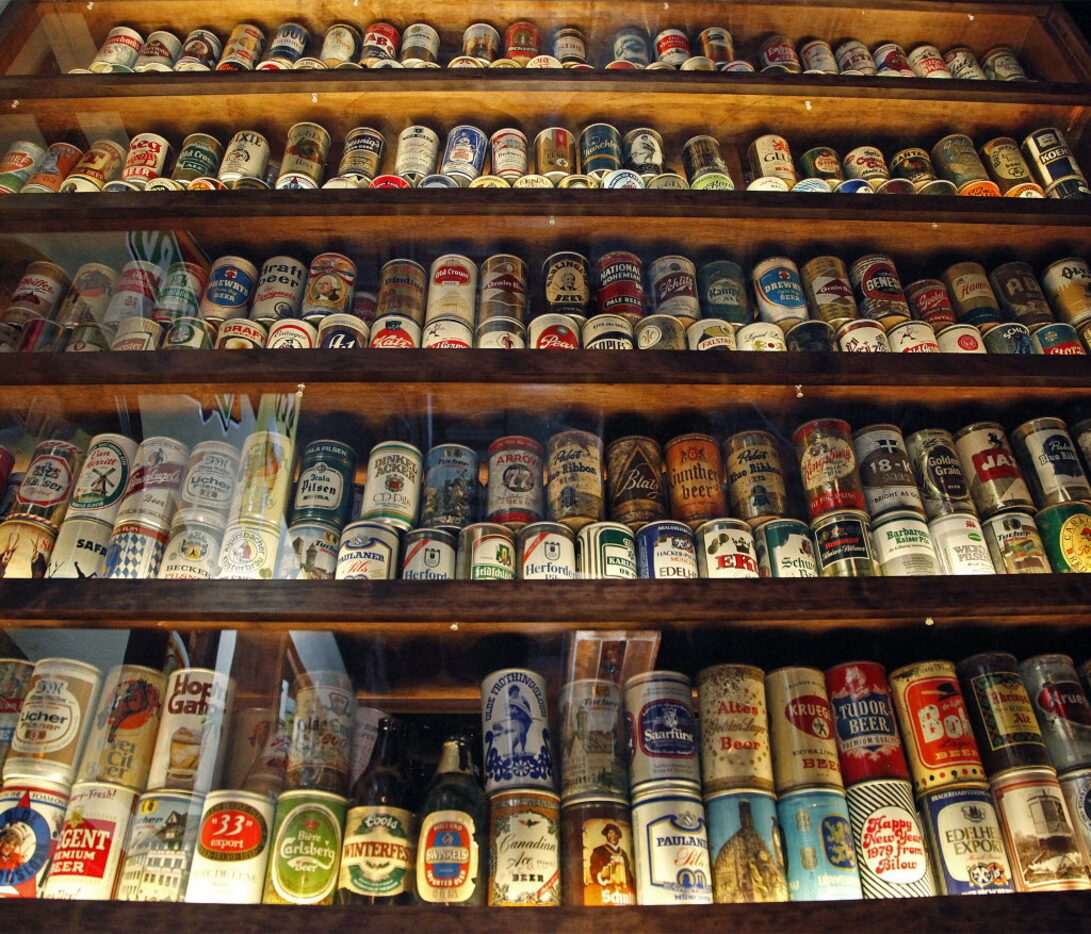 A showcase filled with beer cans and bottles from around the world at Ron's Place in Addison...