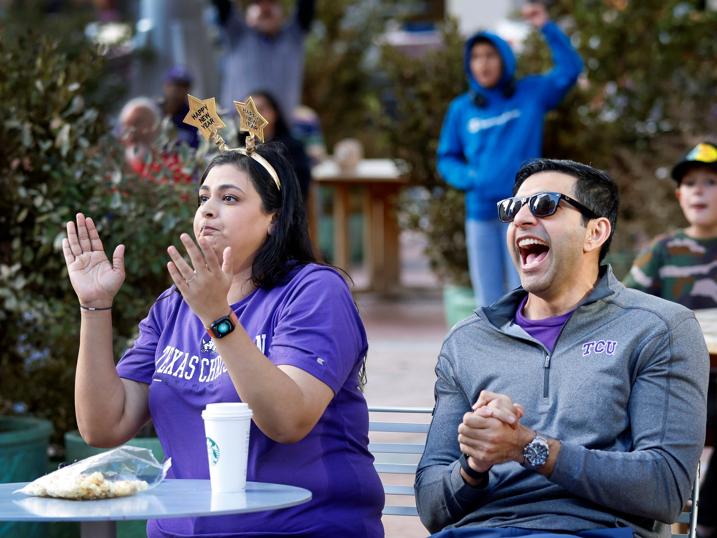 TCU Horned Frogs alums Wardah Iqbal (left) and her husband Azeem Iqbal react to a play...