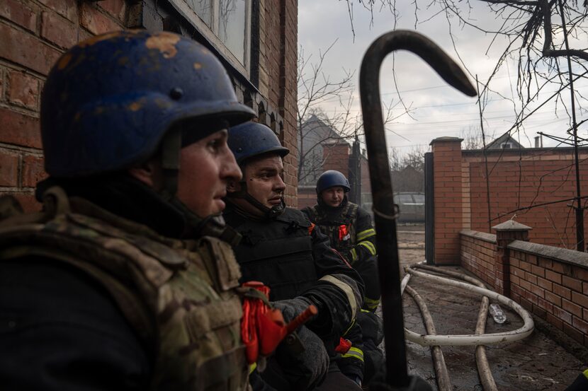 Rescue workers took cover after new explosions as they tried to put out a fire in a house...