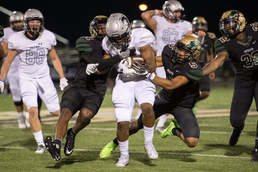 Denton Guyer sophomore running back Noah Cain (7) is brought down by DeSoto junior defensive...