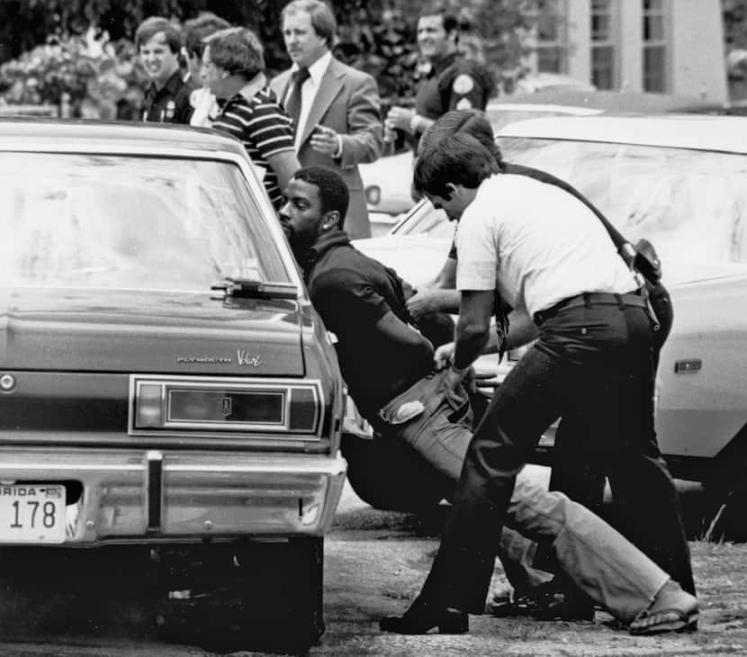 FILE - Police handcuff a suspect during a drug raid in Miami, May 18, 1979. Police said...