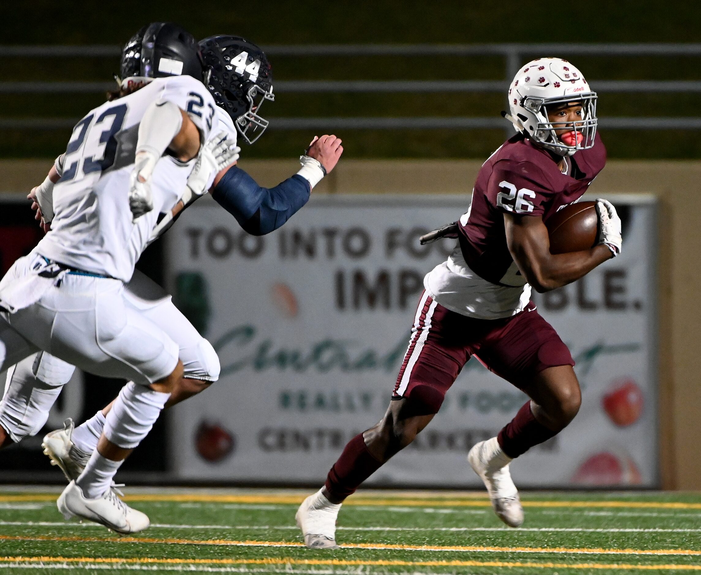 Plano's Kameron Jones (26) runs upfield past Flower Mound's Chase McCall (23) and Ryan...