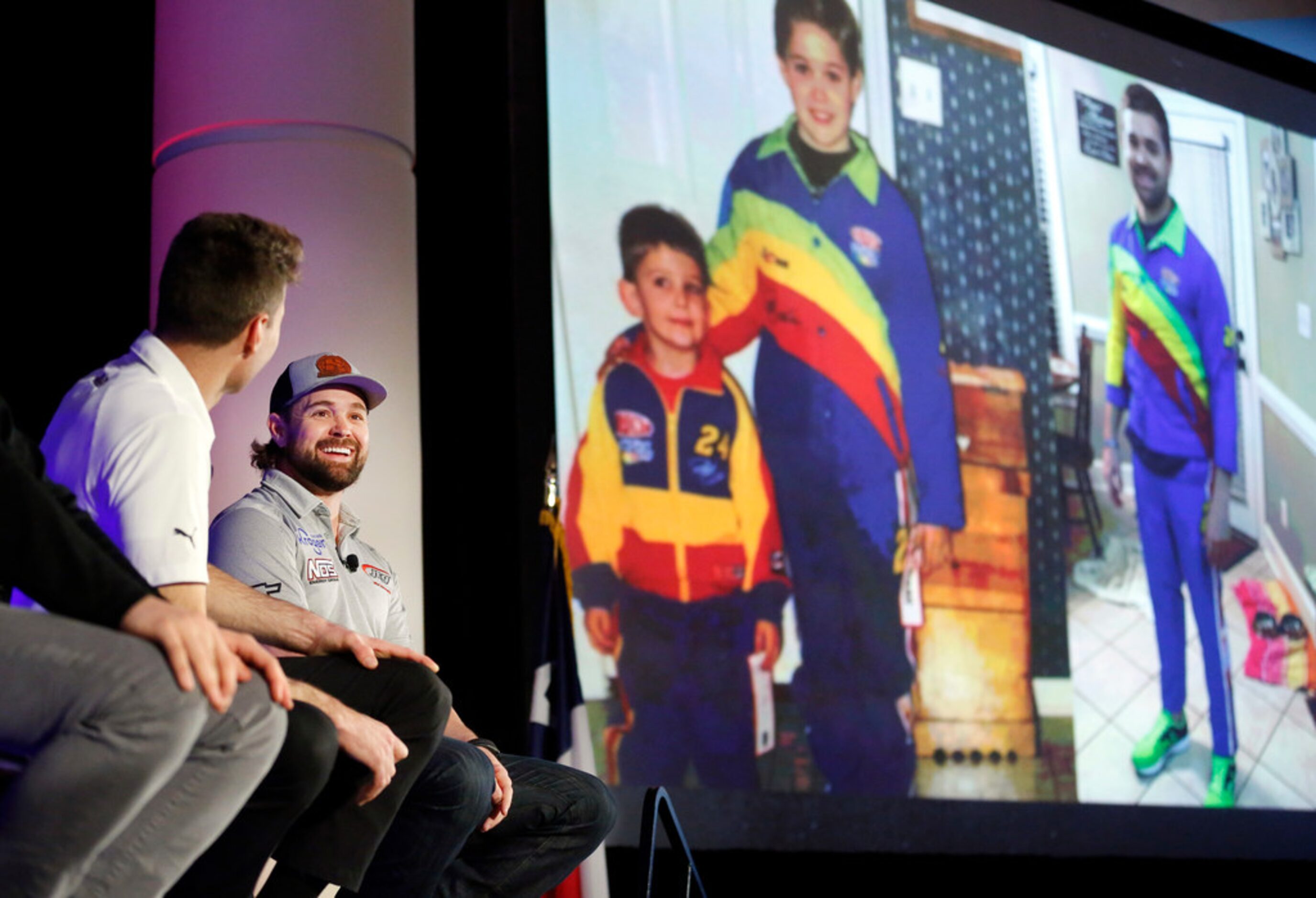 NASCAR Cup driver Ricky Stenhouse, Jr. (right) laughs at his social media post projected ...