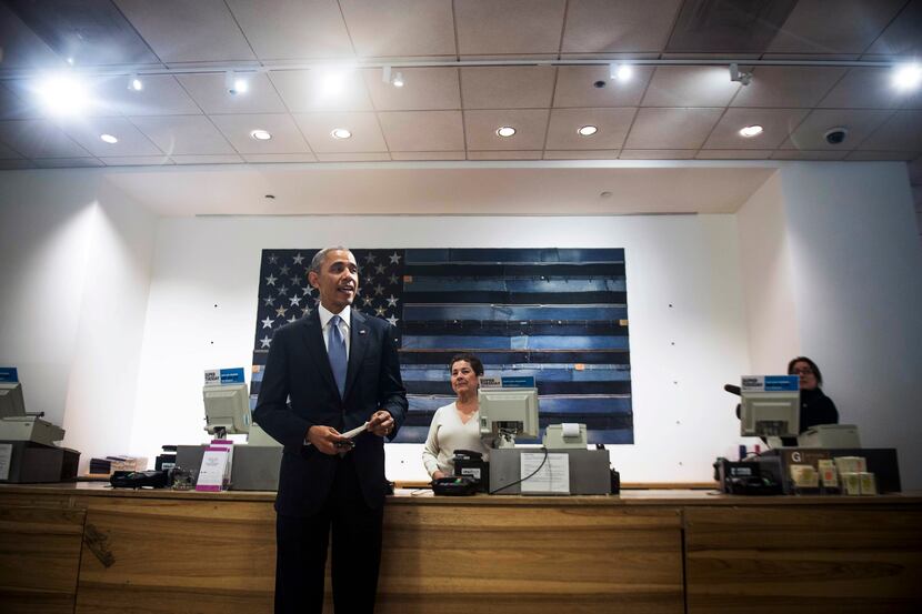 Sonia del Gatto rings up President Barack Obama's purchase, a sweater, at a Gap in New York,...