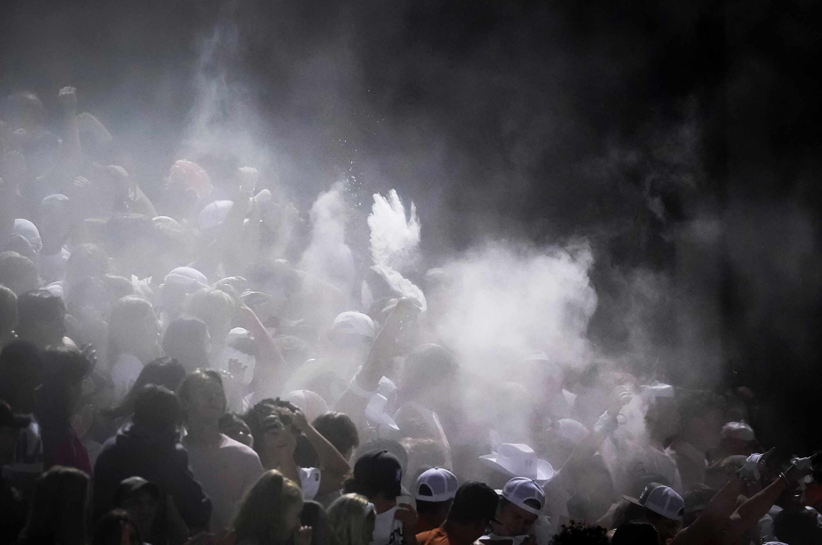 Baby powder flies in the Rockwall student section after tight end Brennan Ray scored on a...