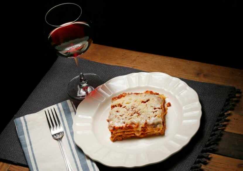 Lasagna with Galina's Meat Sauce, with a glass of red wine. Napkin, placemat, plate and wine...