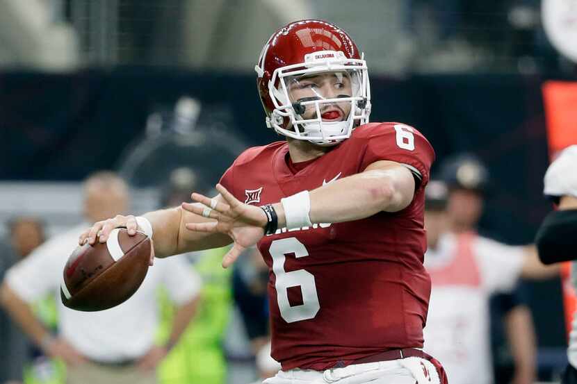 FILE - In this Dec. 2, 2017, file photo, Oklahoma quarterback Baker Mayfield throws a pass...