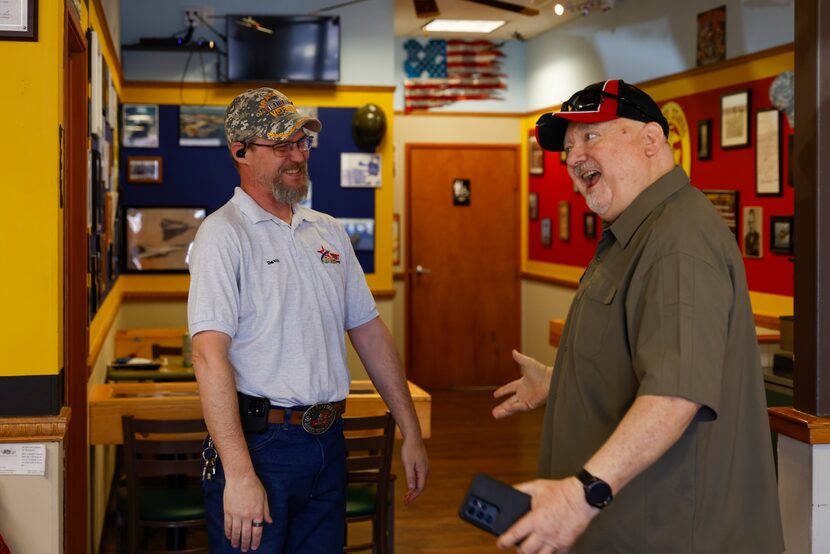 David Jordan and a regular customer, Roy Davis, celebrate on March 26, 2022, after the...