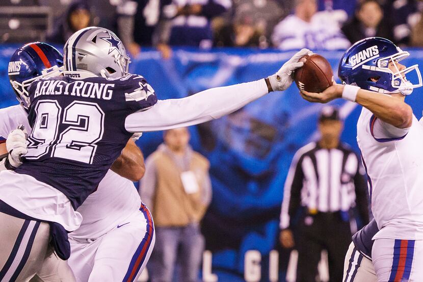 Dallas Cowboys defensive end Dorance Armstrong (92) strips the ball from New York Giants...