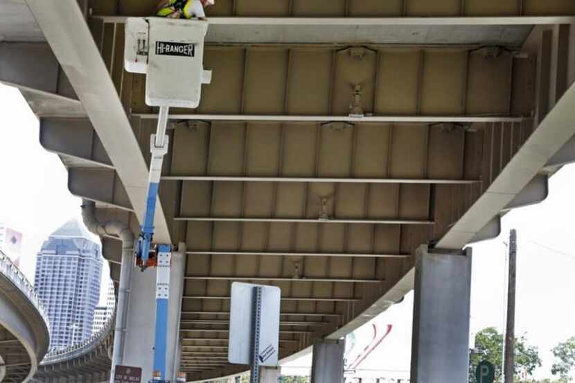 
Crews inspect a freeway near Deep Ellum. A study of the future of I-345 is being expanded...