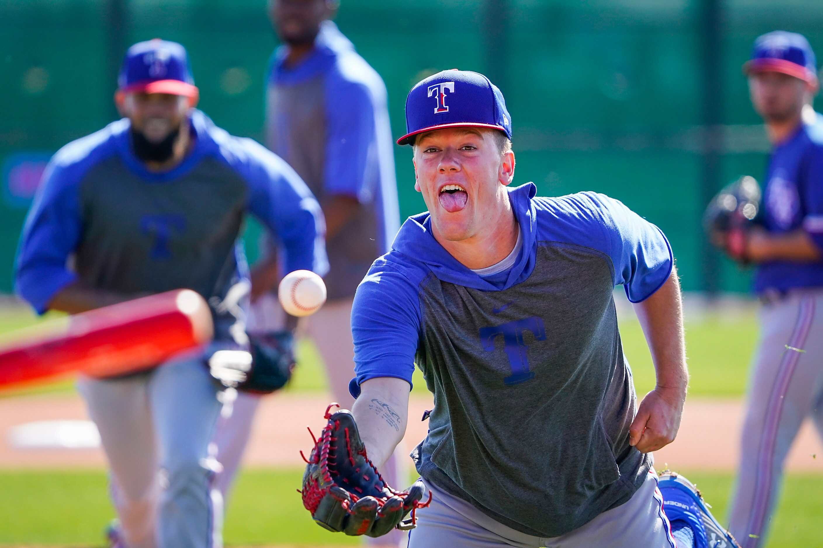 Texas Rangers pitcher Kolby Allard participates in a fielding drill during a spring training...