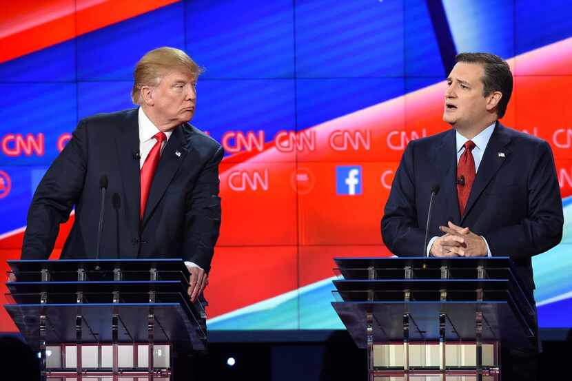  Donald Trump listens as Sen. Ted Cruz makes a point during the GOP presidential debate...