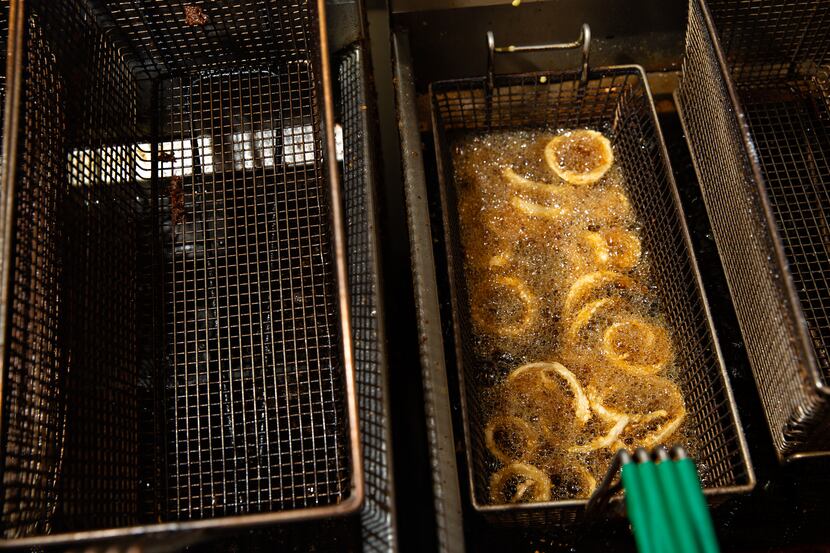 A batch of onion rings are fried to be served at Lakewood Landing in Dallas.