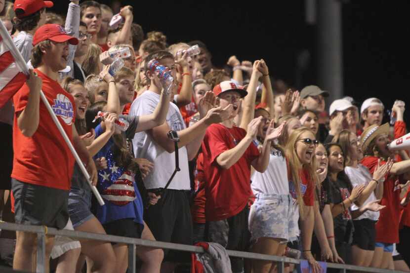 Midlothian Heritage Jaguars fans celebrate a second quarter touchdown during their game...