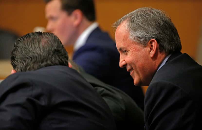 Texas Attorney General Ken Paxton (shown smiling in this 2017 photo) faces two sets of legal...