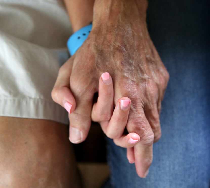 John Gossett and his daughter Erin Gossett hold hands at their Dallas home on Wednesday....