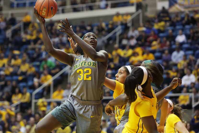 Baylor forward/center Beatrice Mompremier (32) takes a shot while being guarded by West...