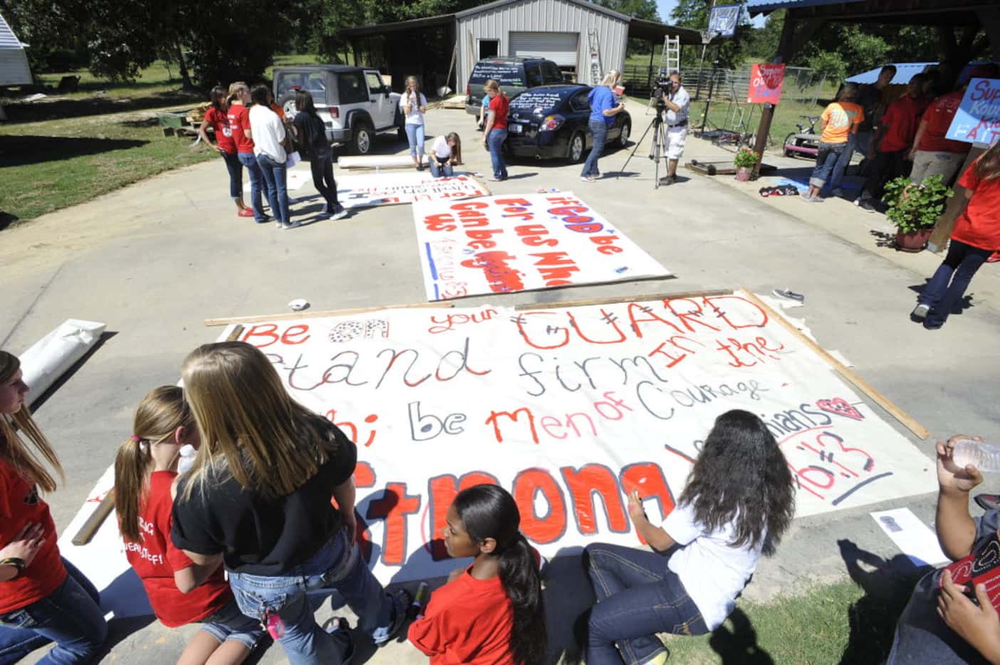 In this 2012 file photo, Kountze cheerleaders, friends and supportive parents make signs. 
