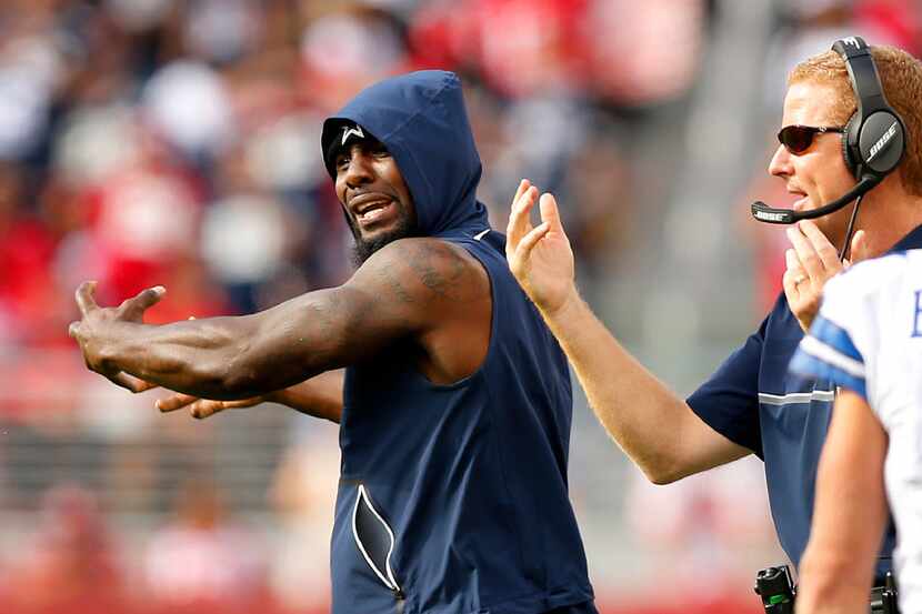 Dallas Cowboys injured wide receiver Dez Bryant (left) yells at fellow wide receiver Brice...