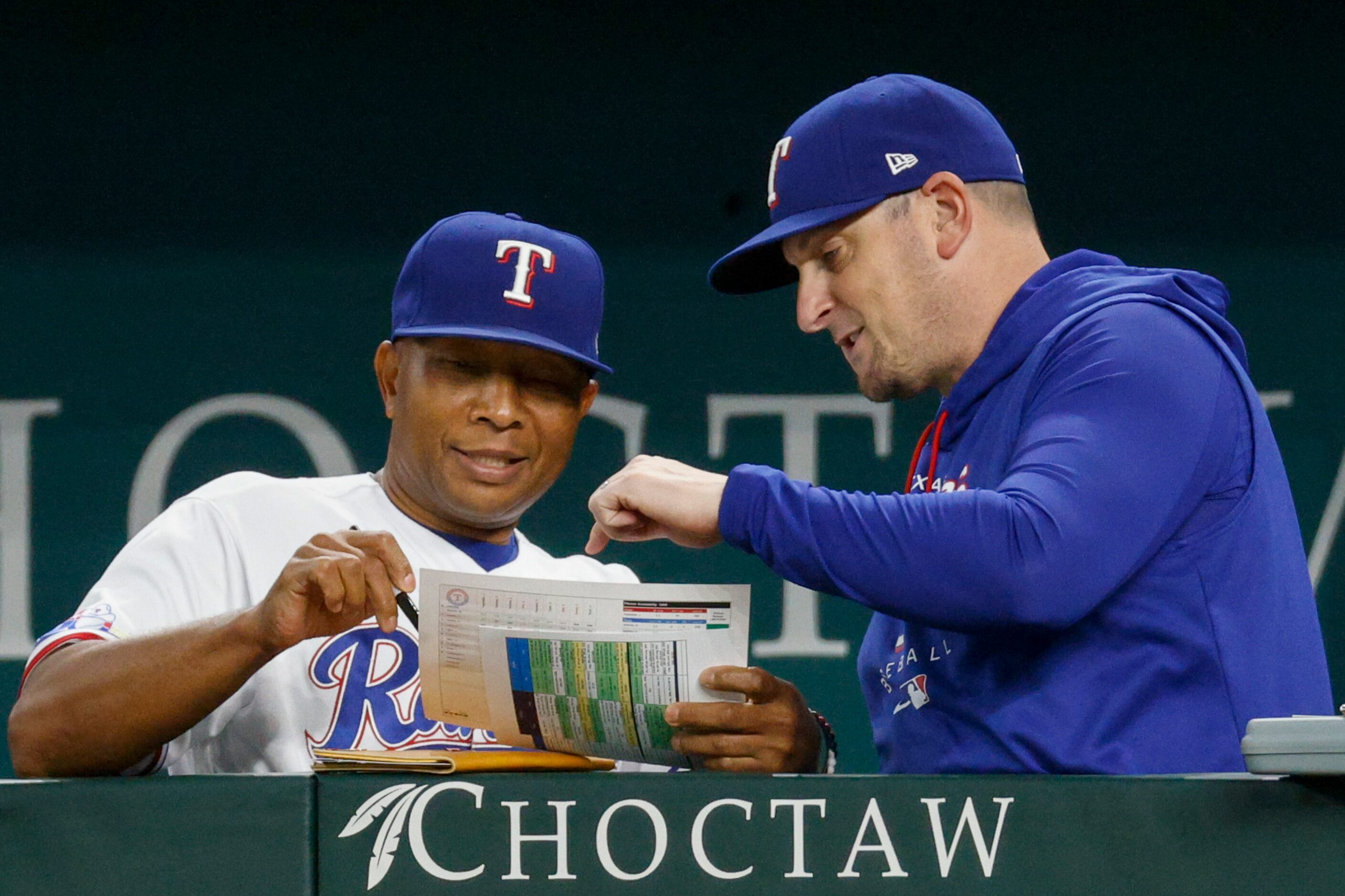 Texas Rangers interim manager Tony Beasley (left) speaks with pitching coach Doug Mathis...