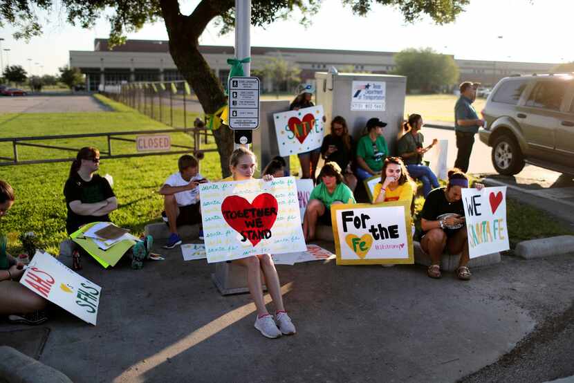 Santa Fe High School supporters gathered by the school Tuesday to wish student and staff...
