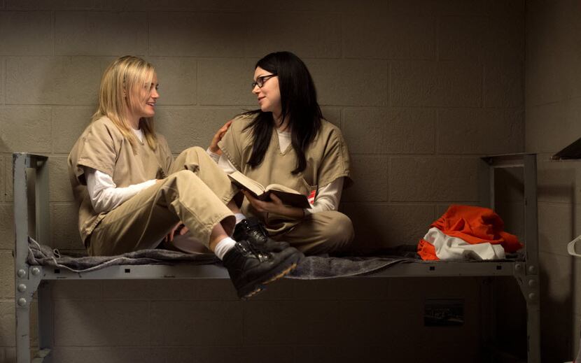 Taylor Schilling, left, and Laura Prepon appear in a scene from the Netflix original series,...