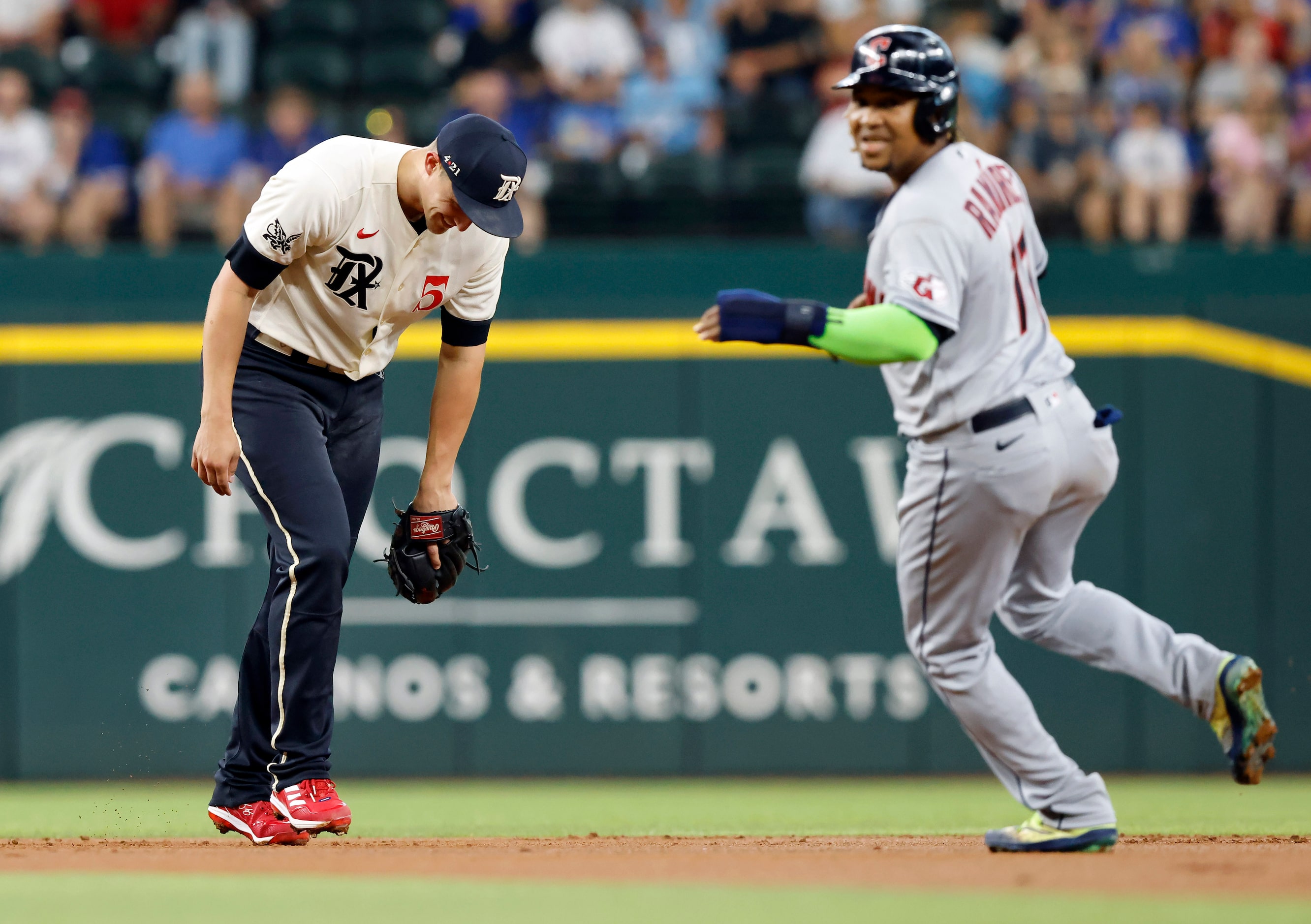 Texas Rangers shortstop Corey Seager (5) laughs after realizing he could have stepped on the...