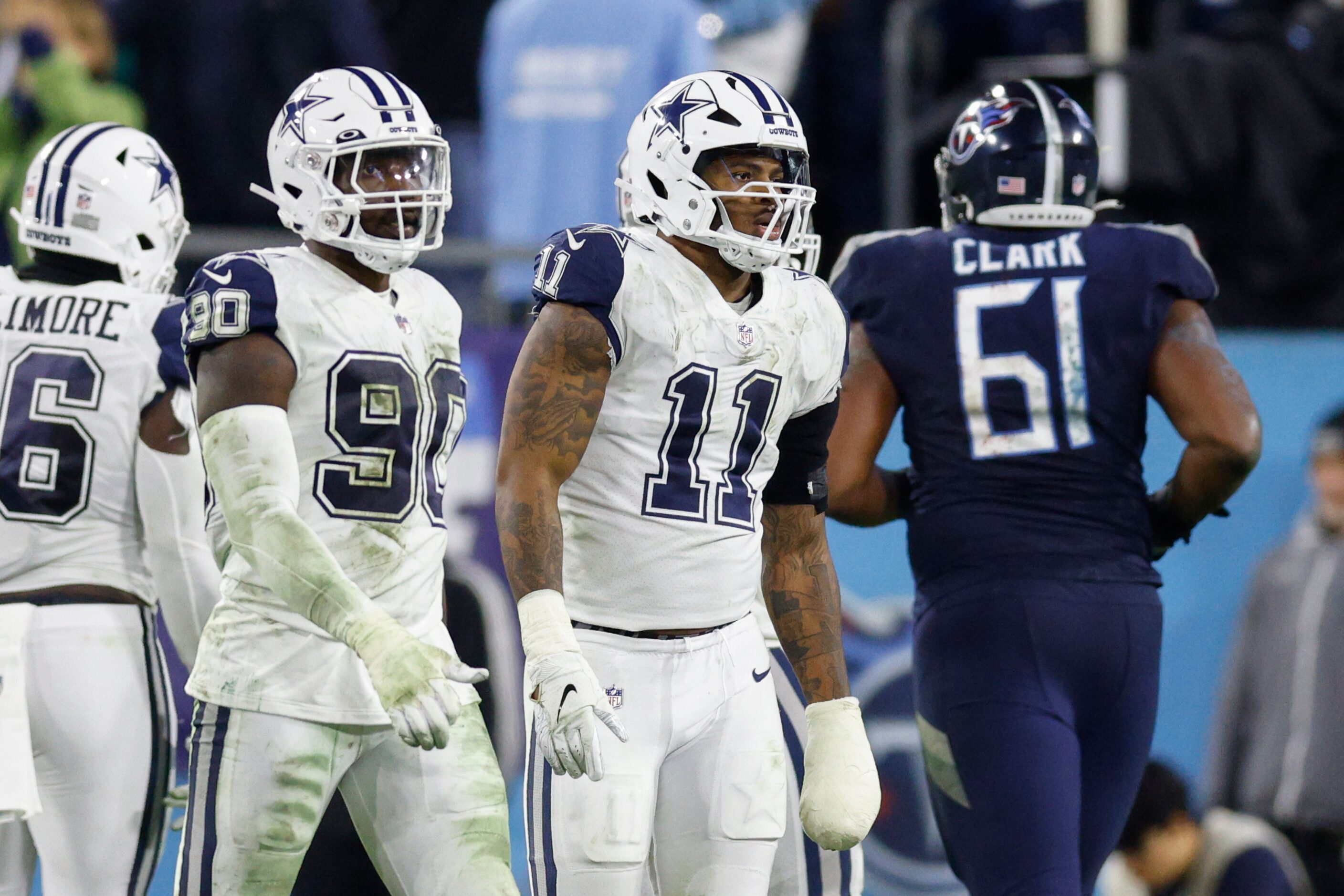 Dallas Cowboys linebacker Micah Parsons (11) and defensive end DeMarcus Lawrence (90) walk...