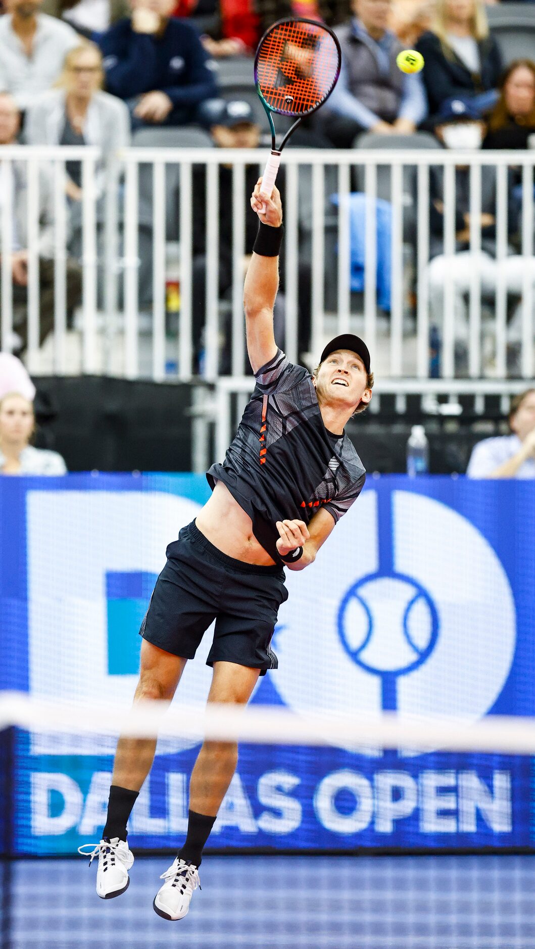 Mitchell Krueger, a Fort Worth native, serves the ball in a match against Yoshihito Nishioka...