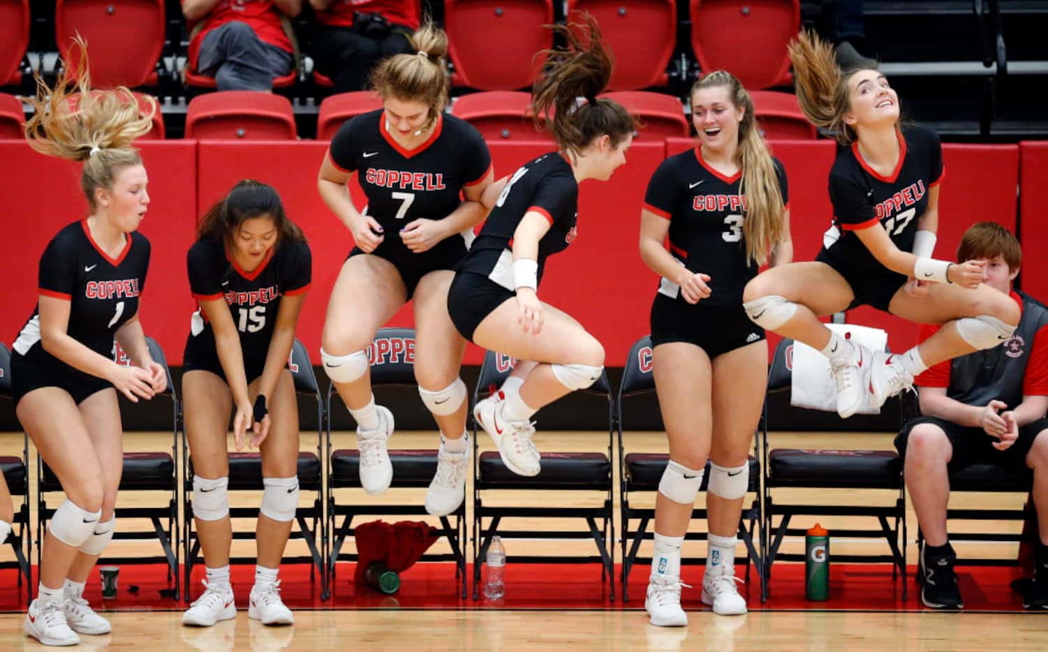 Coppell High senior volleyball player Pierce Woodall (7) joins her teammates in a group...