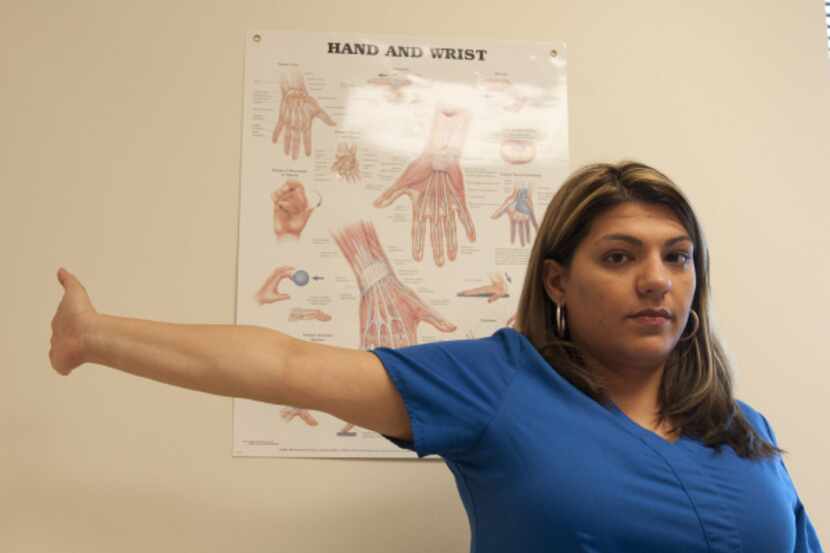 Brenda Alvarez demonstrates Step 11 of an arm exercise to alleviate hand pain.